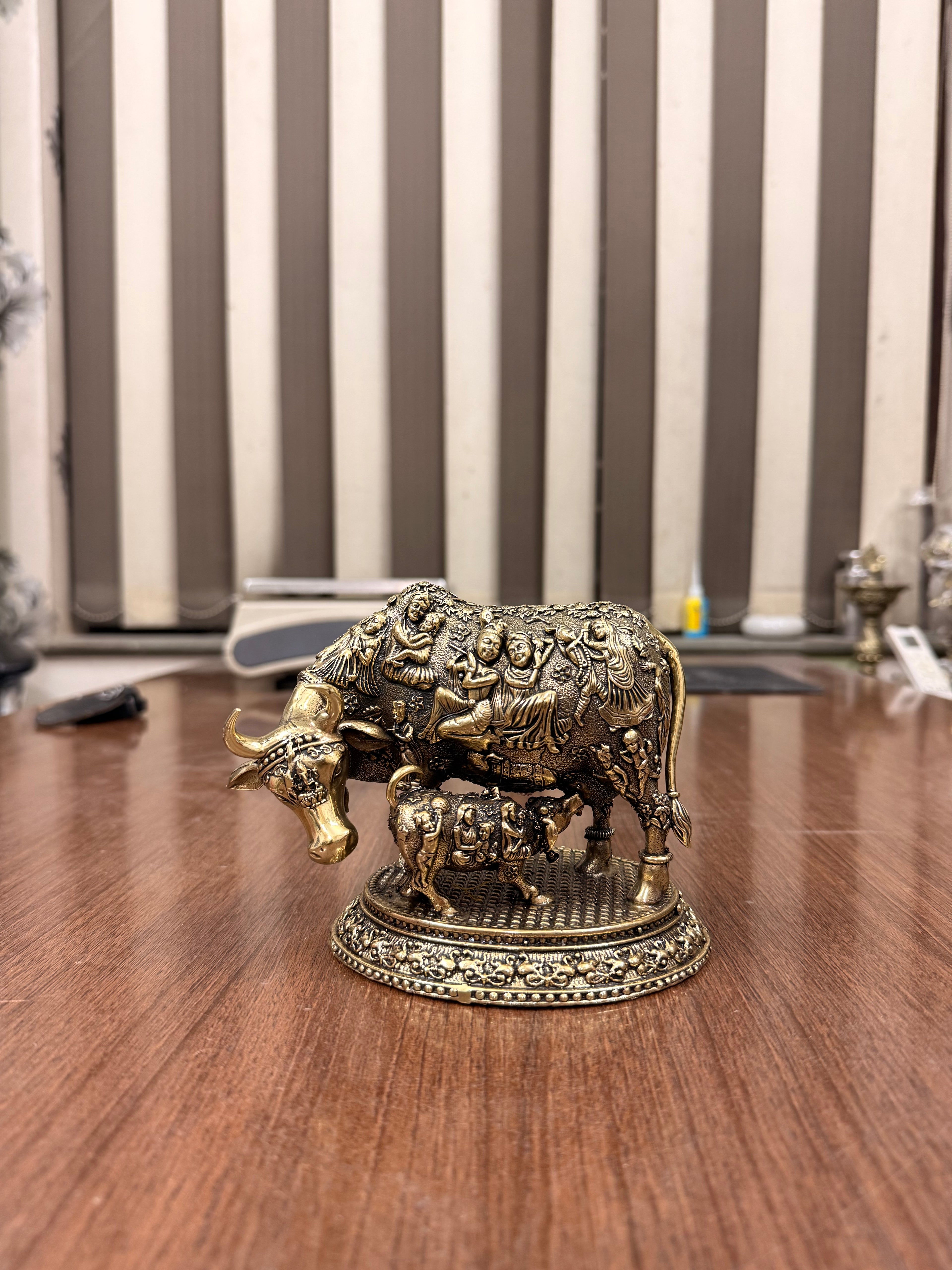Handcrafted Brass Kamdhenu Cow with highly detailed work and figuring on body with Raslila radha krishna by silverartisians