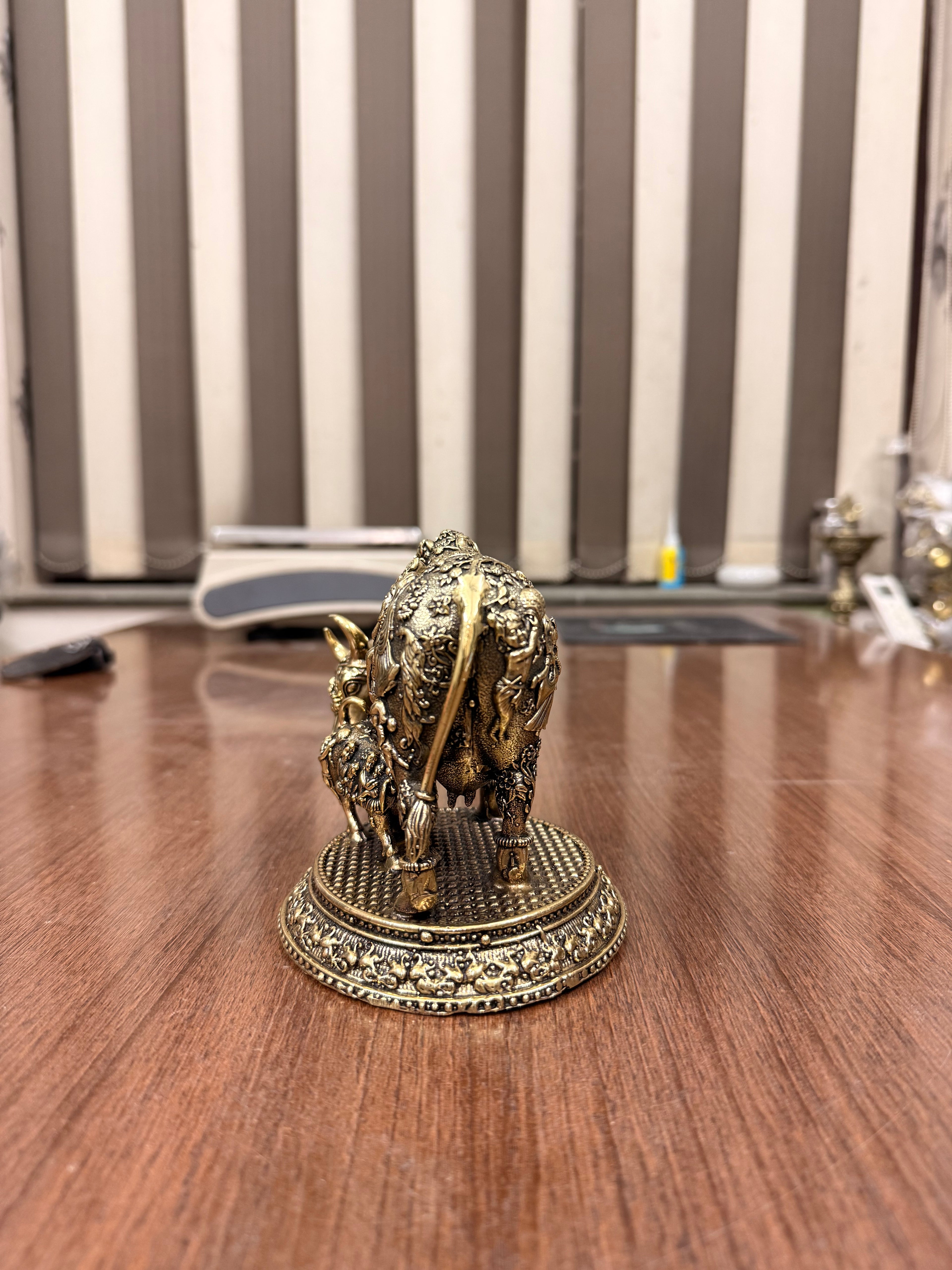 Handcrafted Brass Kamdhenu Cow with highly detailed work and figuring on body with Raslila radha krishna by silverartisians