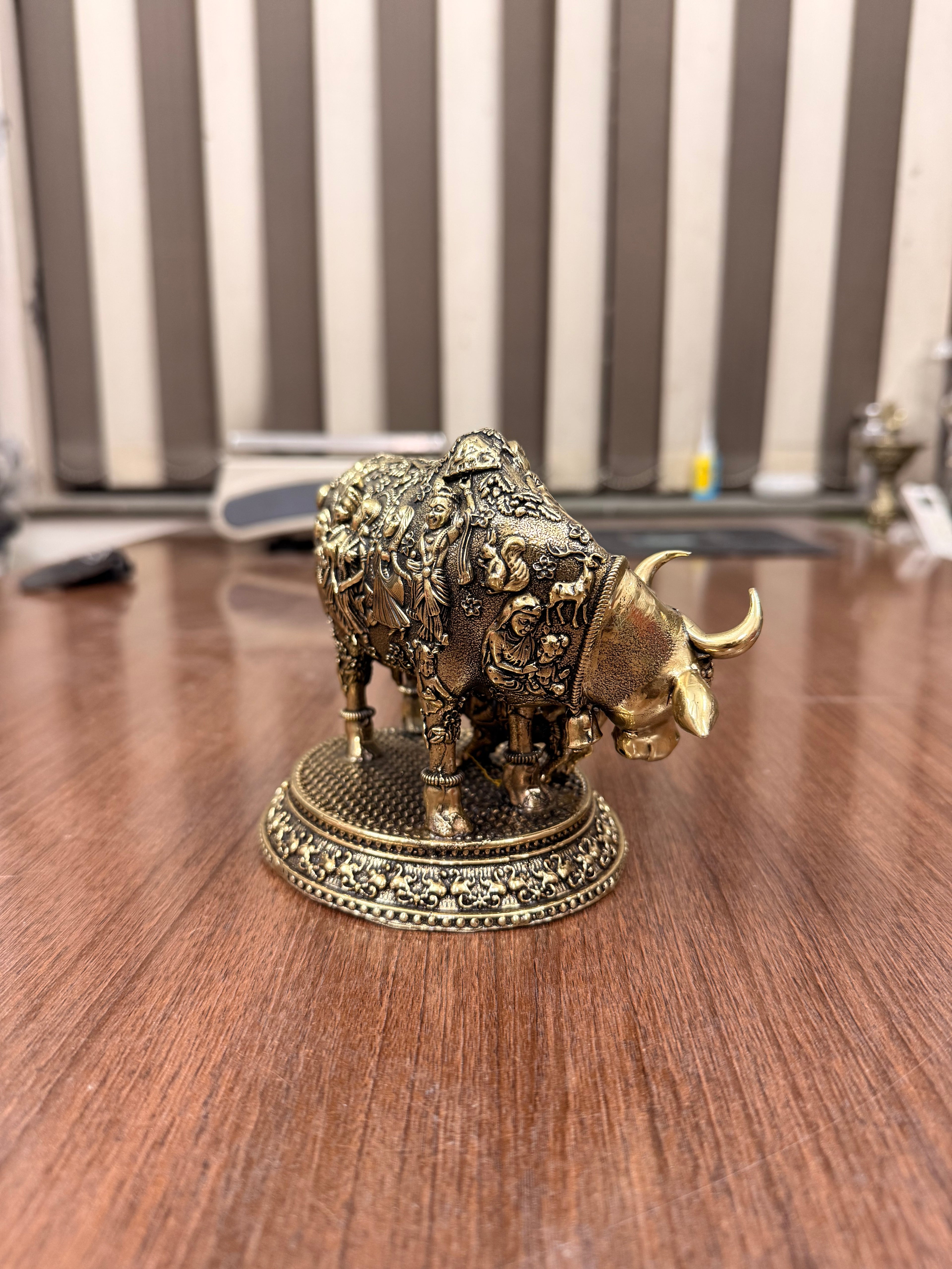 Handcrafted Brass Kamdhenu Cow with highly detailed work and figuring on body with Raslila radha krishna by silverartisians