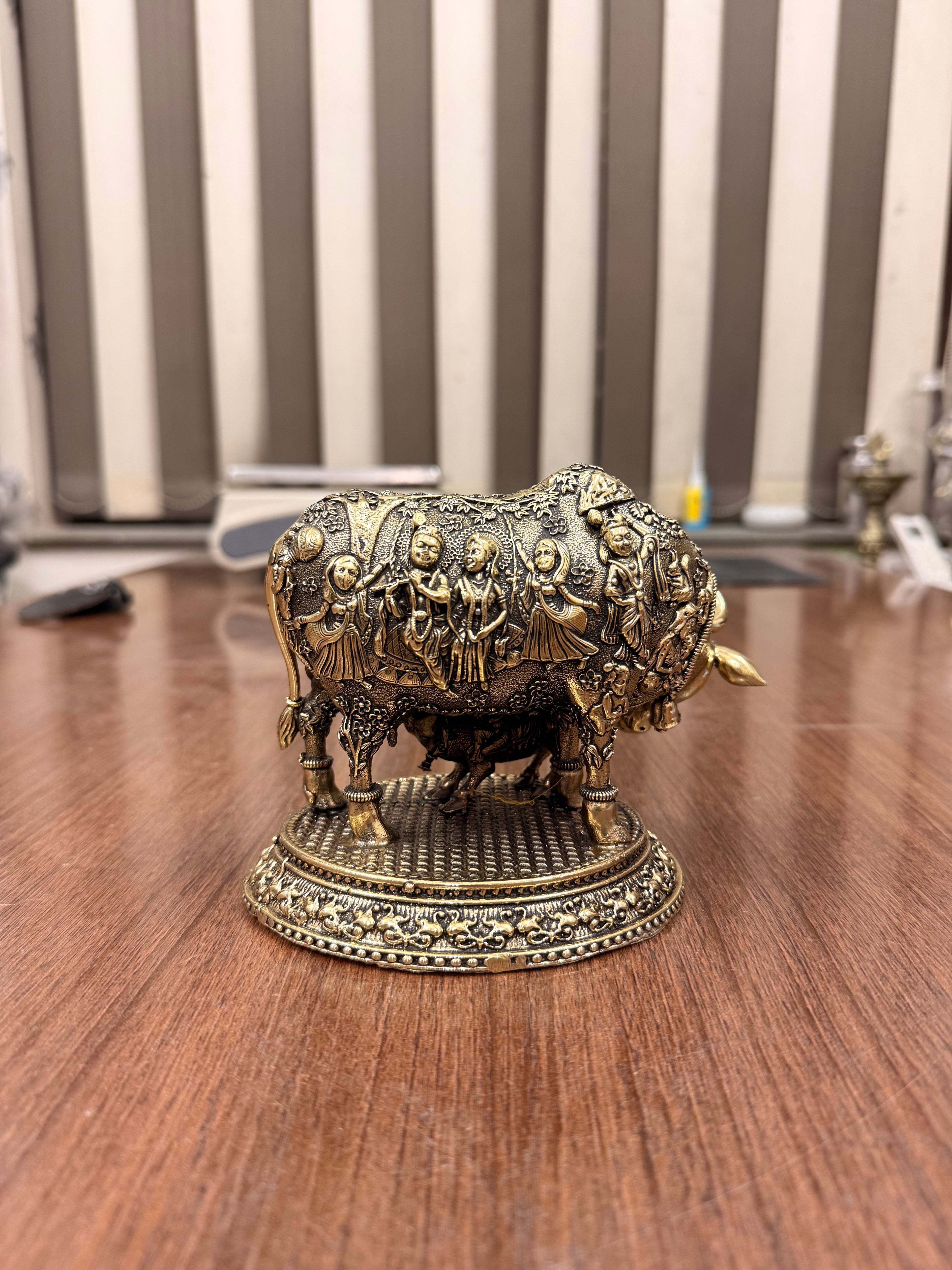 Handcrafted Brass Kamdhenu Cow with highly detailed work and figuring on body with Raslila radha krishna by silverartisians