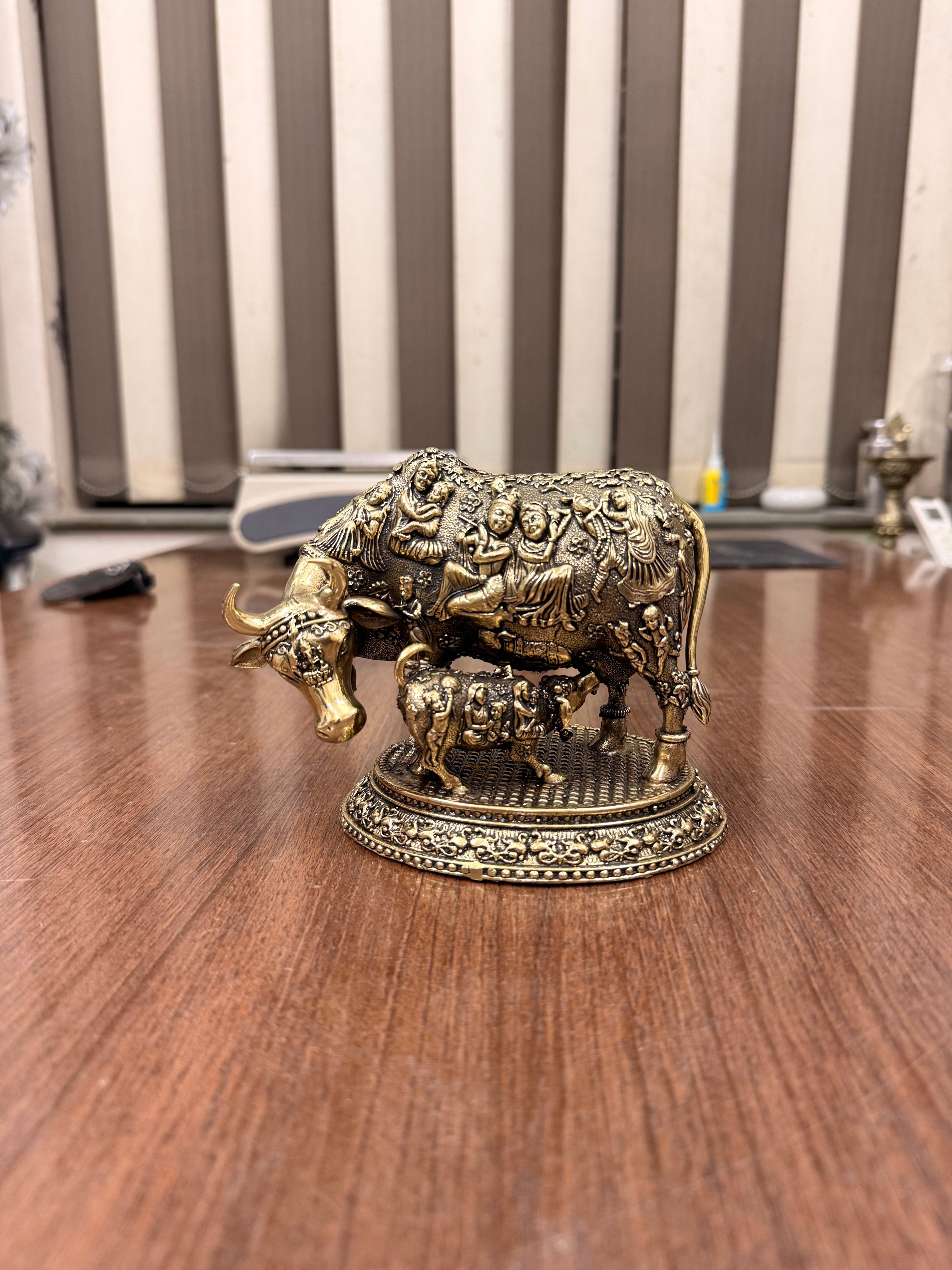 Handcrafted Brass Kamdhenu Cow with highly detailed work and figuring on body with Raslila radha krishna by silverartisians